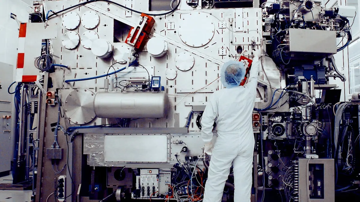 An engineer working beside an ASML prototype extreme ultraviolet lithography system